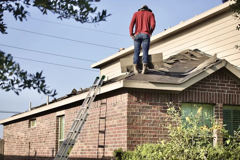 Professional roofer working on a residential roof in High Pointe